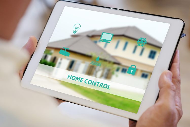 Man using digital tablet with smart home controls